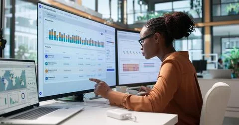 Treasury Manager Analyzes Real-time Cash Dashboard On Laptop For Forecasting. Stock Photos