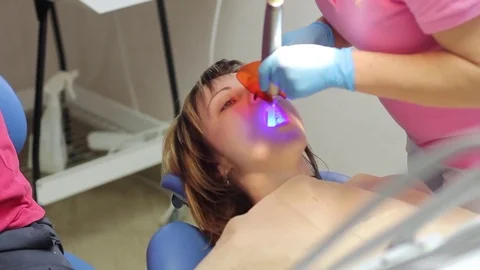 Treatment of the patient's teeth using a paint lamp, UV light Stock Footage 72353889