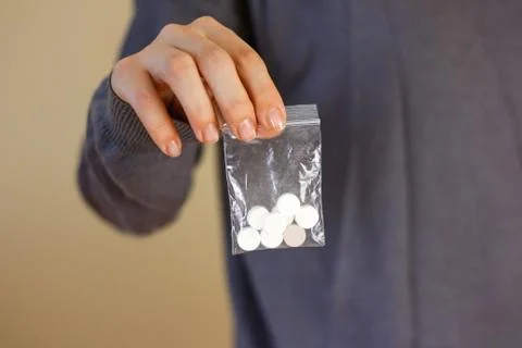 Treatment tablets. Close-up of a white pack pills in woman's fingers. 스톡 사진
