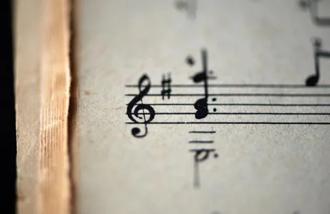 Treble clef and musical notes in the old musical notebook close up 스톡 사진
