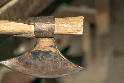 A tree is being cutting down by a traditional axe Stock Photos