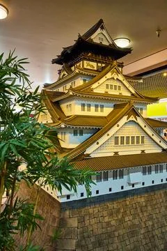 Tree beside artistic rendering of Osaka Castle on hill in Japantown 스톡 사진
