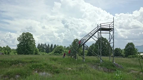 Tree bike riders going up a run in for speed in slow motion Stock Footage 107569586