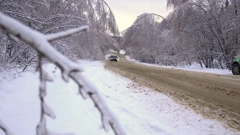 Tree branches bent under the weight of snow and ice over the road Stock Footage 71657107