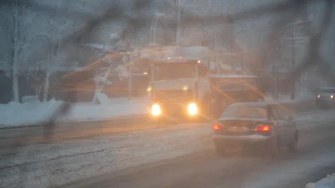 Tree branches. buses. snow-covered streets in the city. defocus. refocus. car Stock Footage 126596397