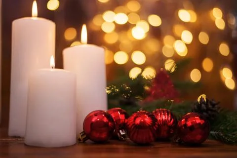 Tree branches, cones, bokeh lights, candles, Christmas balls . Stock Photos