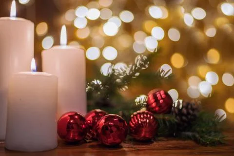 Tree branches, cones, bokeh lights, candles, Christmas balls . Preparation fo Stock Photos