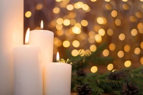 Tree branches, cones, bokeh lights, candles. Preparation for the New year Stock Photos