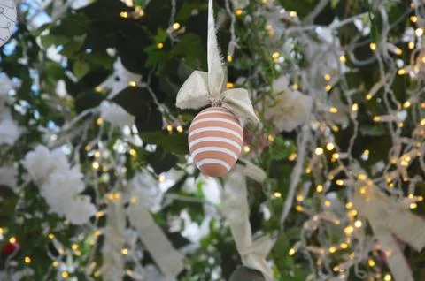 Tree branches decorated with painted Easter eggs, flowers, ribbons, lights. F Stock Photos
