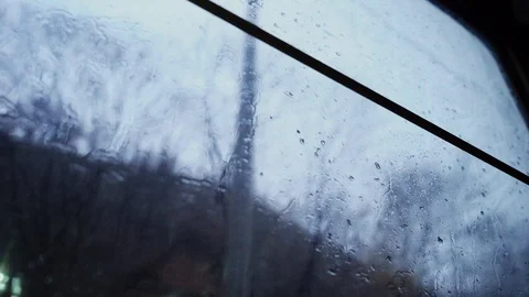 Tree branches without leaves outside the window. Raindrops on the window. Stock Footage 123399734