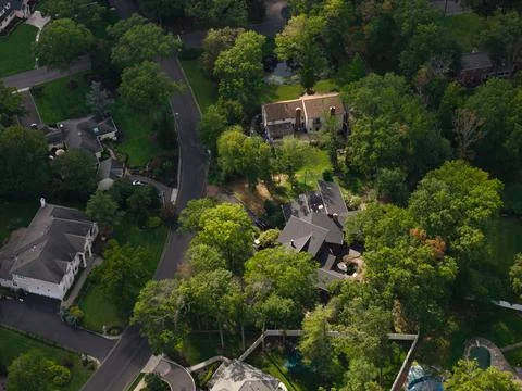 Tree Canopy Surrounding Closely Spaced Suburban Homes Stock Photos