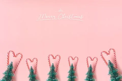 Tree Christmas tree with candy cane hanging on pastel pink wall with white Me Stock Photos