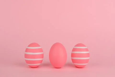 Tree Easter decorated pink eggs in a row. Pink background. Copy space. Stock Photos