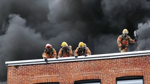 Tree firefighters battling structure fire Stock Footage 114946209