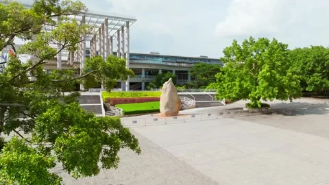 Tree framed approach to the GDUT main entrance in Guangzhou China 스톡 동영상 345954655