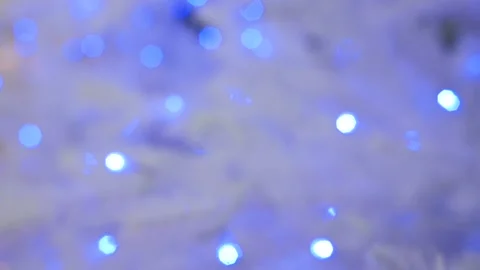 The tree glows blue. Christmas light bulbs on a white tree Stock Footage 143854120