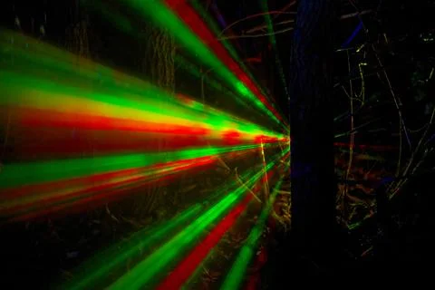 Tree with green and red light Laser rays spreading at night. Stock Photos
