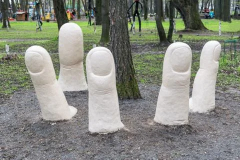 The tree grows from the palm of the hand, which is under the ground. Stock Photos