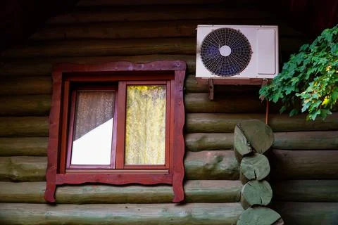 Tree house window, log cabin house, air conditioning on the house Stock Photos