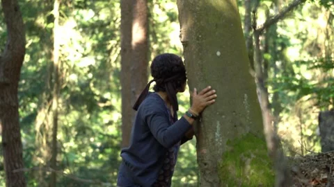 Tree hugging blindfold exercise to deepen grounding trust and sensory Stock Footage 331052528