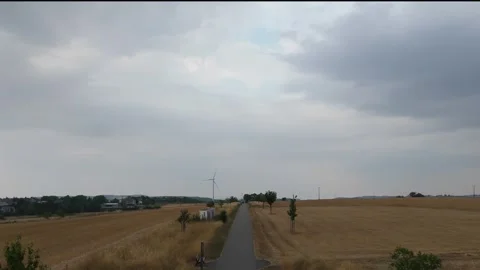 Tree lined country road through harvested Hunsrück farmland 動画素材 340367948