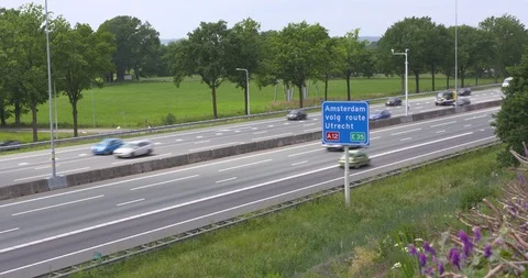 Tree lined Dutch highway A12, vehicular traffic + road sign Amsterdam Utrecht Stock Footage 109155629