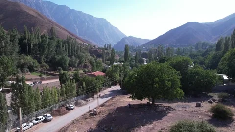 Tree-lined North Road highway runs through a mountain valley with parked cars, Stock Footage 343805977