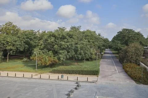Tree lined pathway through Turia Gardens urban park in Valencia Spain Stock Photos