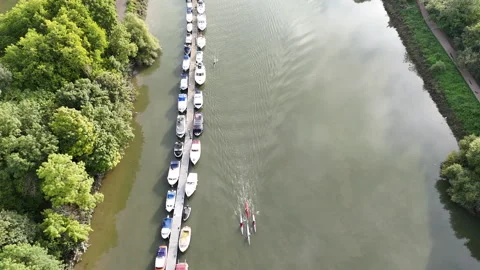 Tree Lined River and Moored Boats Aerial Stock Footage 346253075