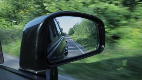 Tree-Lined Road Reflected in the Side Mirror of a Moving Car Stock Footage 347008112