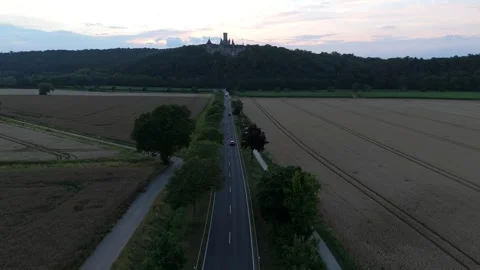 Tree-lined road toward Marienburg Castle at sunset in Lower Saxony Stock Footage 340159285