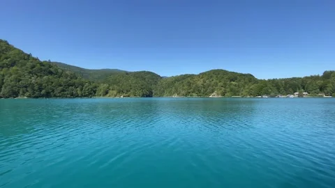 Tree lined shore and smooth waters of  Plitvice Lakes National Park Stockbeeldmateriaal 160696497