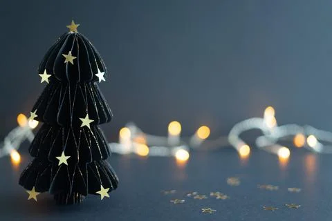 The tree is lit up with lights, creating a festive and warm atmosphere Stock Photos