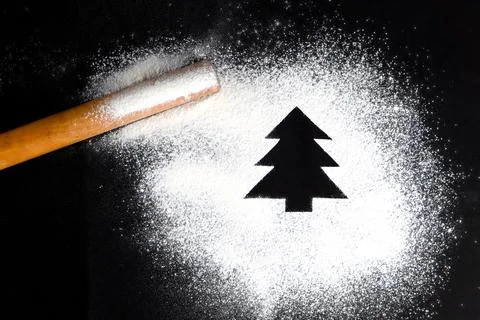Tree made of flour on a black background. Preparing for Christmas Stock Photos