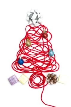 A tree made of red thread and ribbon, ball, small box, pine cone on white bac Stock Photos