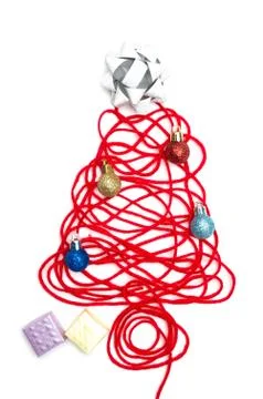 A tree made of red thread and ribbon, ball, small box on white background Stock Photos