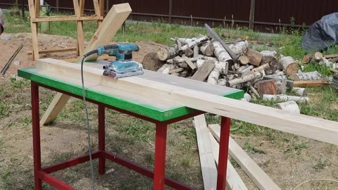 Tree. natural wood in the shape of a rectangle. work piece. a man uses a tool to Stock Footage 243663940
