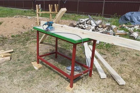 Tree. natural wood in the shape of a rectangle. work piece. a man uses a tool Stock Photos