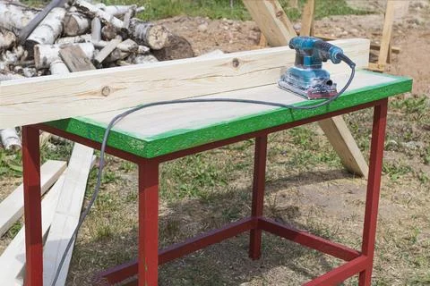 Tree. natural wood in the shape of a rectangle. work piece. a man uses a tool Stock Photos