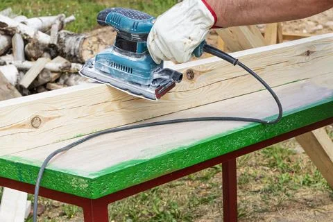 Tree. natural wood in the shape of a rectangle. work piece. a man uses a tool Stock Photos