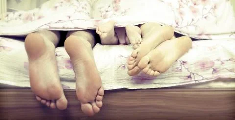 Tree pairs of legs in the bed Stock Photos