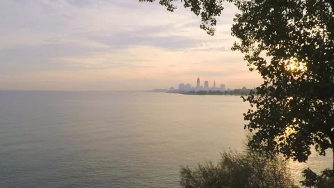 Tree pull back from  Skyline Cleveland through trees - Color Corrected Stock Footage 90141529