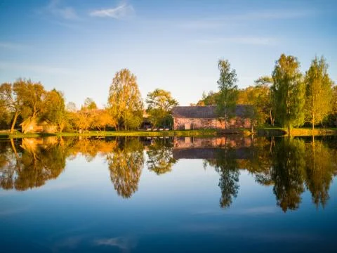 Tree Reflection in the Lake on a Sunny Spring Day - Autumn Colours 写真素材