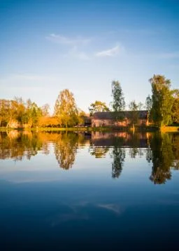 Tree Reflection in the Lake on a Sunny Spring Day - Autumn Colours 写真素材