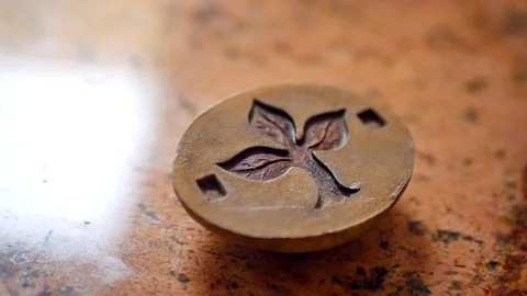 Tree sapling with leaf design carved into stone pendant ORBITING. Stock Footage 93524240
