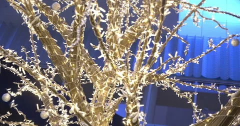 Tree sculpture wrapped with Christmas string lights. Close up from below, Stock Footage 147218612