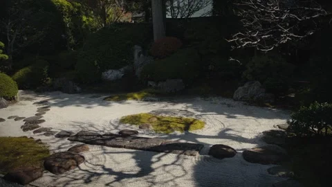 Tree shadows moving on raked sand in a japanese zen garden Stock Footage 324875589