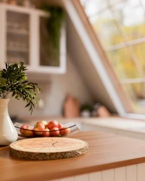 Tree stump chopping board with apples in glass plate on wooden cooking coun.. 스톡 일러스트