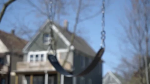 Tree Swing Swaying in the Wind with House in Background Stock-Footage 137429064