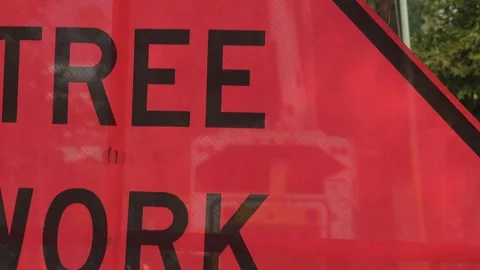 Tree Work sign while tree branches are cut off Stock Footage 314463144